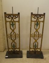 A pair of modern cast iron stands, on a plinth  28"h