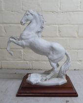 A Kaiser porcelain model of a rearing horse, on a plinth  14"h