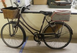 A lady's 1960/70s Cameo bicycle with 25"dia wheels, on a wicker basket