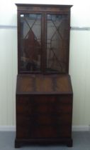 A reproduction mahogany bureau bookcase, the upper section over a fall flap, over four graduated