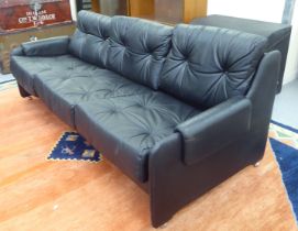 A modern Pirelli moulded stitched black hide upholstered three person low back settee with