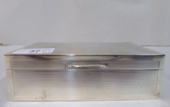 A silver cigarette box with straight sides, a hinged lid and engine turned decoration  Birmingham