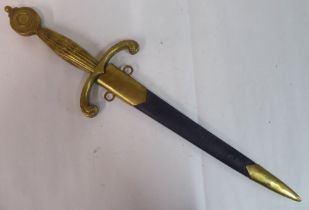 A 19thC Continental style dagger with a brass handle and hilt, the blade 11"L in a fabric covered