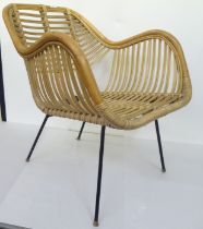A mid century bamboo and woven cane chair, raised on wrought metal legs