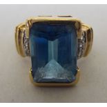 A 9ct gold, blue topaz and diamond ring