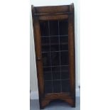 A 1920s oak bookcase, the lead framed and glazed door revealing three shelves, raised on bracket