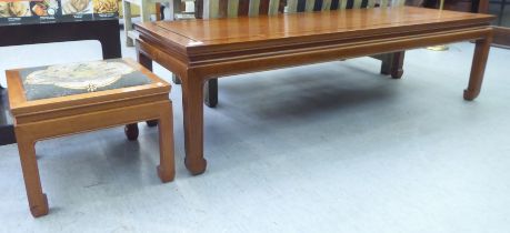 Two mid 20thC Chinese fruitwood occasional tables, each raised on chamfered, square legs  largest