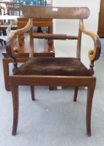 A William IV and later bar back, open arm chair with a carved horizontal rail and upholstered