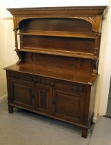 A modern Victorian design oak dresser with two open shelves, over two drawers and two panelled