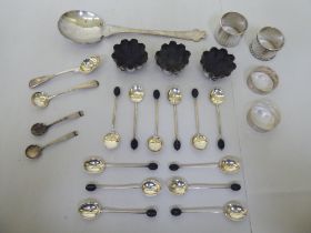 Silver items: to include a set of three salt cellars, a serving spoon and four various napkin rings