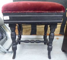 An Edwardian black painted height adjustable music stool, raised on ring turned legs