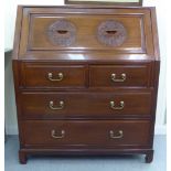 A modern Chinese fruitwood bureau with a fall flap, over two short/two long drawers, raised on block