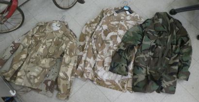 British and US military camouflage uniforms: to include tunics; and another of waterproof design (