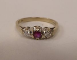 An 18ct white gold claw set, three stone, ruby and diamond ring