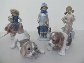 Five Lladro figures: to include a boy dressed in winter clothing, walking a dog  8"h