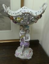 A late 19thC Dresden porcelain table centrepiece with a floral encrusted, pierced basket, elevated