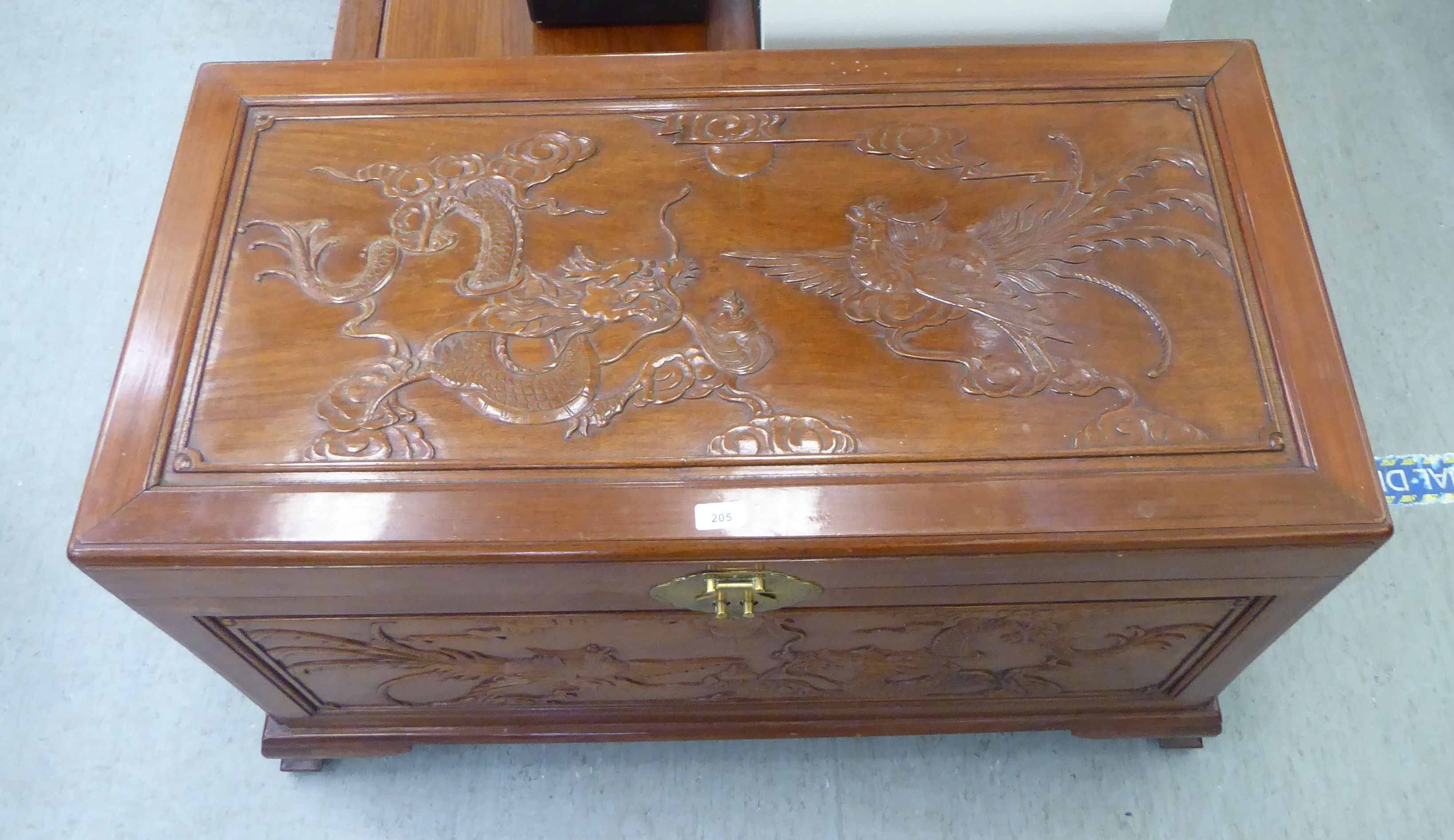 A mid 20thC Chinese fruitwood chest, allover carved with dragons, raised on bracket feet  24"h  41"w - Image 2 of 4