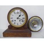 An early 20thC oak mantel clock, faced by a Roman dial, on a plinth  11"h  10"w; and a later