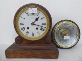 An early 20thC oak mantel clock, faced by a Roman dial, on a plinth  11"h  10"w; and a later