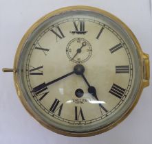 A Smiths Astral brass cased bulkhead timepiece, faced by a Roman dial  8"dia