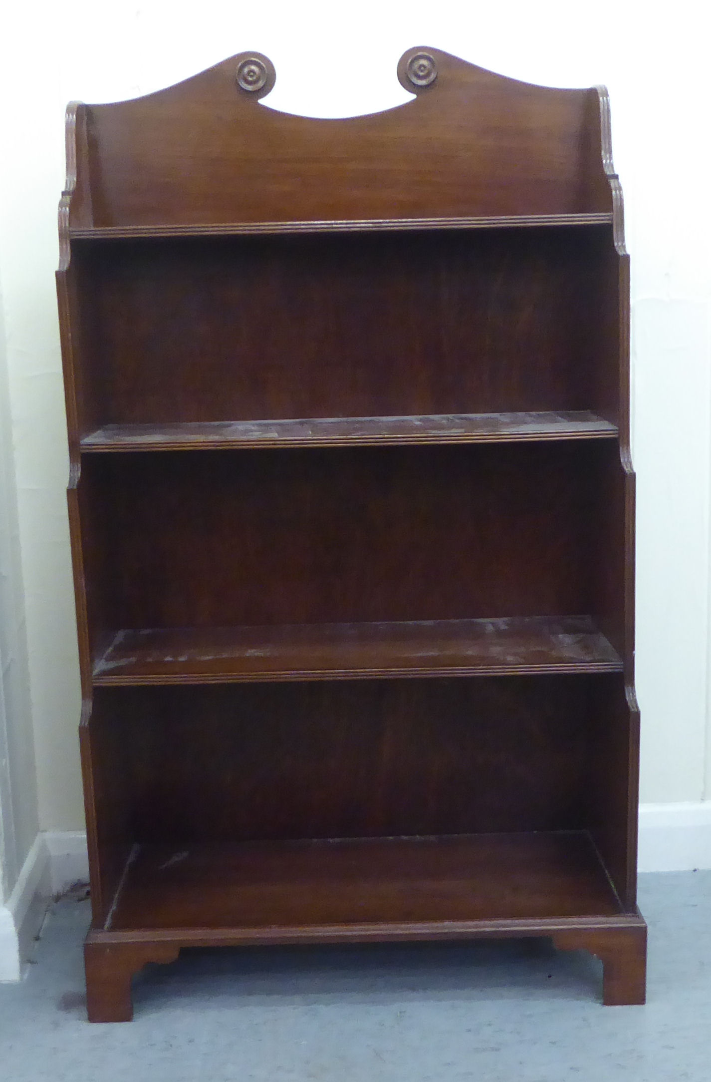 A modern Regency style mahogany four tier waterfall front bookcase, raised on bracket feet  41"h