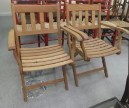 A pair of Lister teak folding garden chairs