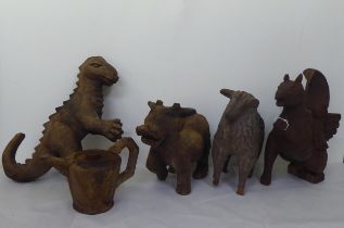 Carved wooden figures: to include a hippogryph  14"h; and a dinosaur  16"h