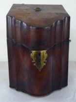 A Georgian mahogany serpentine front knife box with opposing cast brass bail handles, an angled,
