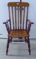 A late Victorian lathe back chair, raised on turned legs