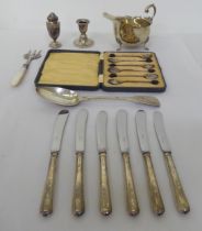 Silver collectables: to include butter knives with loaded handles; a sauce boat and dwarf
