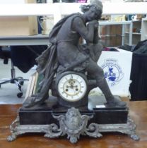 A late 19thC mantel clock, surmounted by a seated, disconsolate Knight, on a plinth and attendant