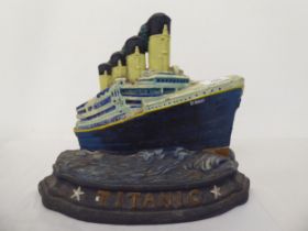 A modern painted cast iron door porter, fashioned as the Titanic  10"h