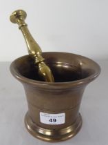 An antique bronze mortar  5"dia; and a double ended brass pestle