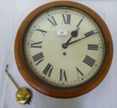 A late Victorian oak cased wall timepiece; the movement faced by a Roman dial  15"dia