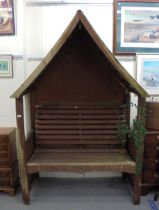 A modern teak pergola, incorporating a bench  80"h  54"w  32"deep