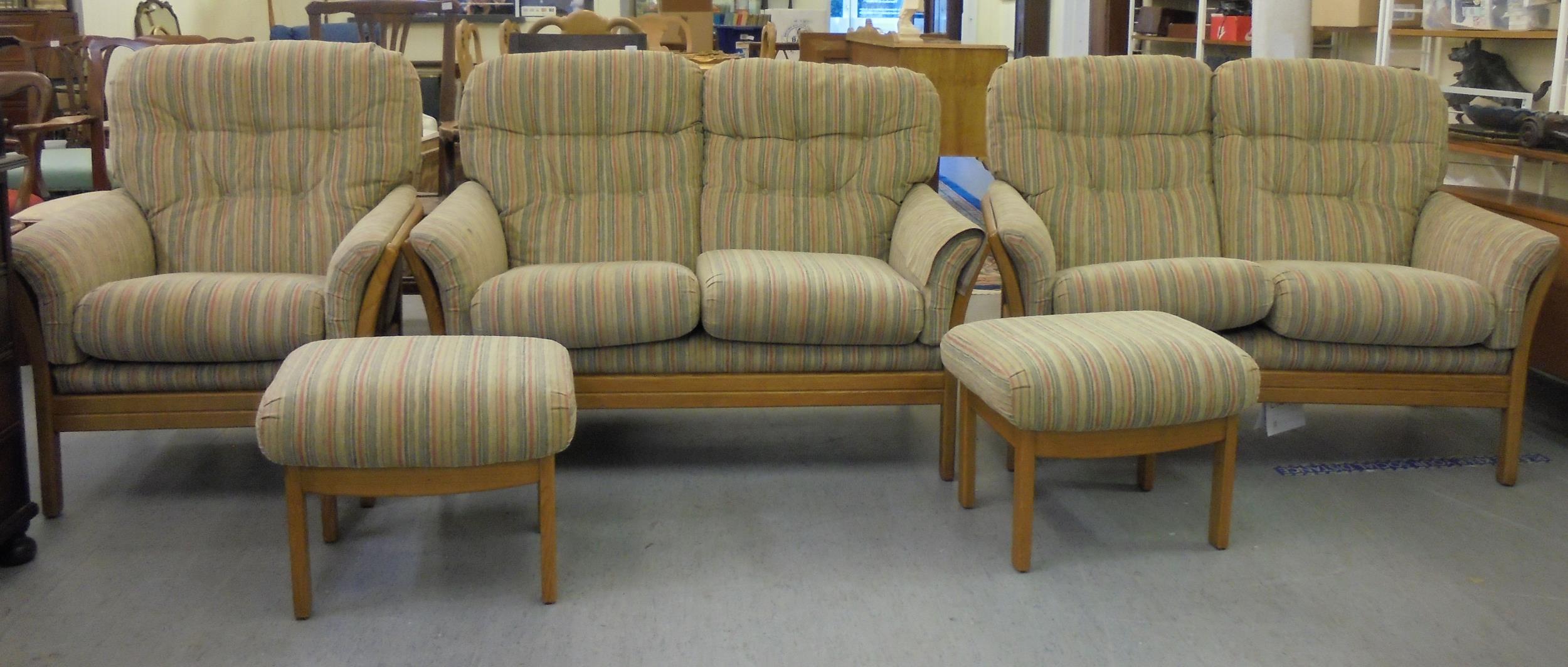 A suite of Cintique beech framed furniture,  comprising two, two person settees, an arm chair and