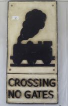 A painted cast iron sign 'Crossing No Gates'  23" x 12" and a fire back