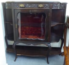 A late Victorian mahogany display cabinet with a glazed door, flanked by open shelves, raised on