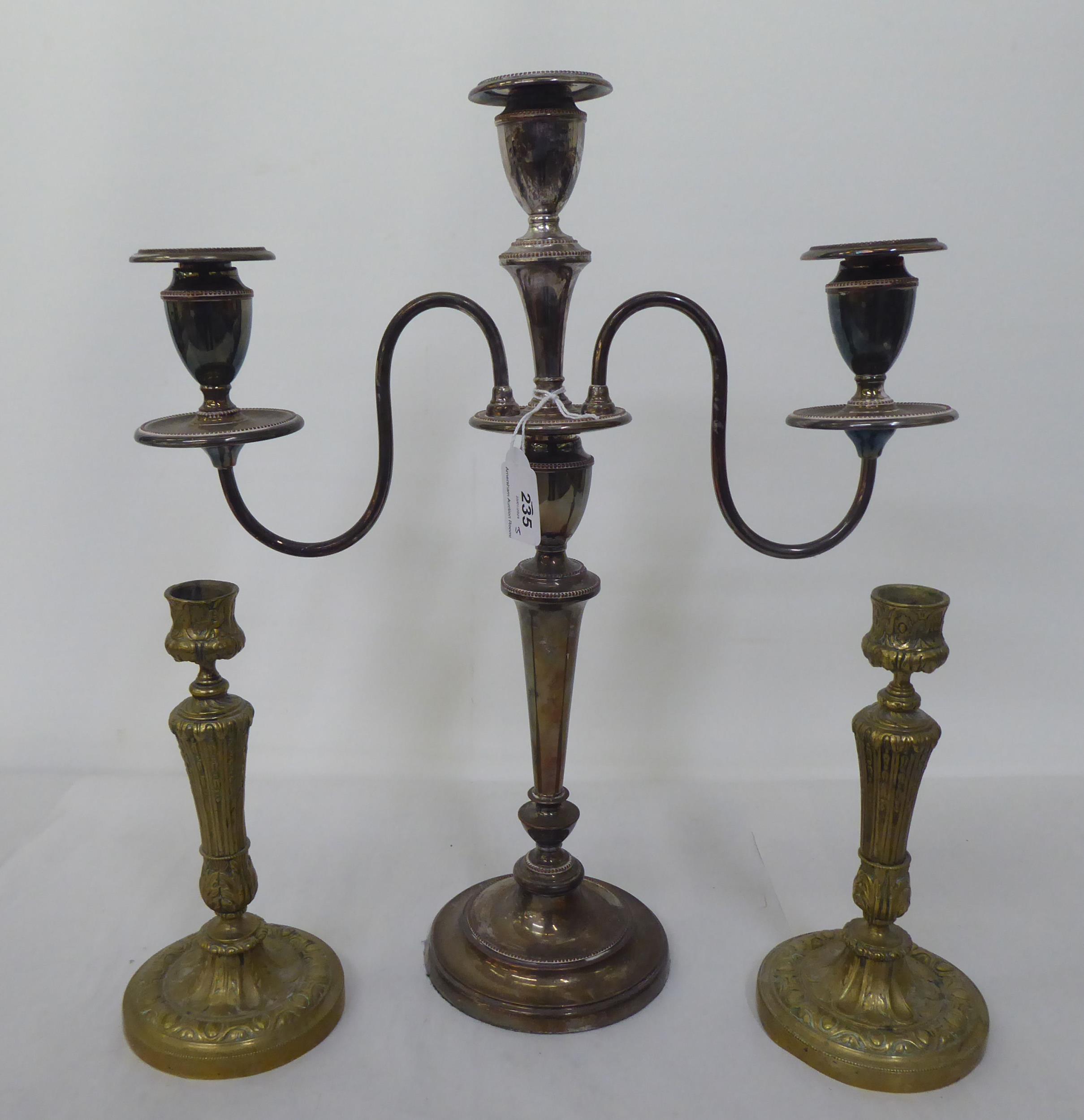 A silver plated three branch candelabra, decorated with beading  17.5"h; and a pair of brass