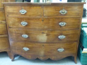 An early 19thC mahogany bowfront dressing chest with two short/three long drawers, raised on bracket