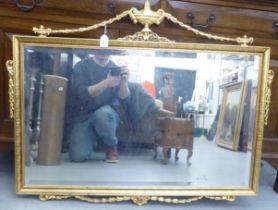 A modern Regency style mirror, the bevelled plate set in an ornately decorated gilt frame  30" x 37"