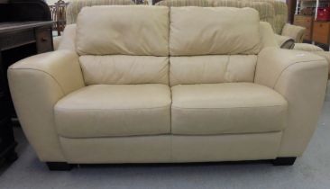 A modern cream hide upholstered two person settee