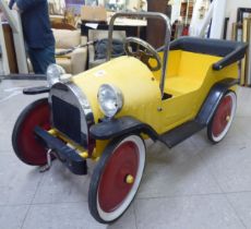 A child's mid thC metal pedal car, decorated in yellow and black livery  36"L