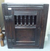 A late 18thC oak wall hanging food cabinet with a single door  29"h  23"w