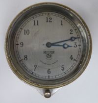 A vintage Smiths of Cricklewood Works motorcar dashboard timepiece with a bezel winder and