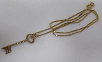 An 18ct gold pendant, fashioned as an 18 Key, on a fine box link neckchain and ring bolt clasp