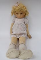 An early 20thC doll, the moulded and painted head on a fabric body  27"h