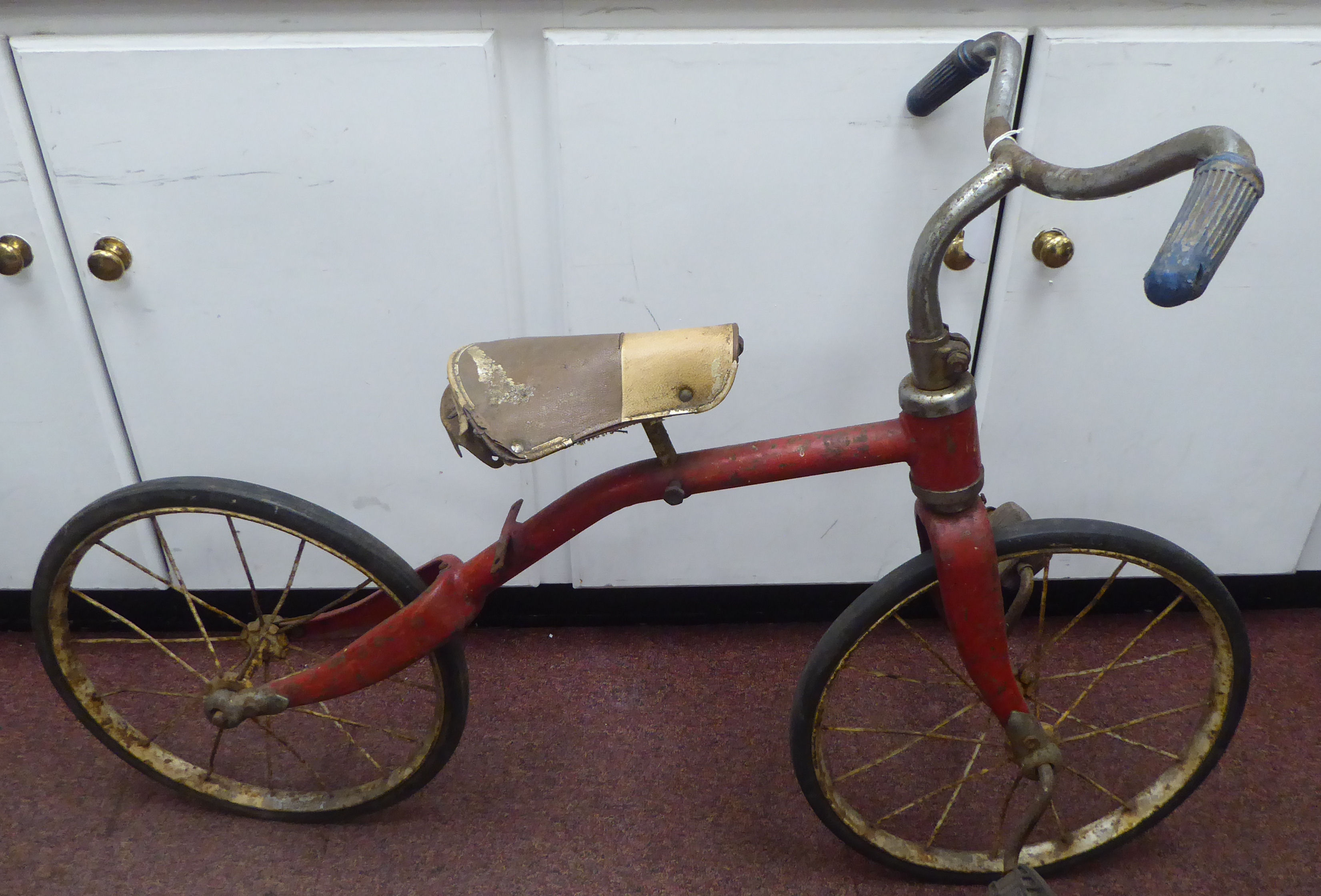A child's vintage Tri-ang bicycle with a red painted frame and downswept handlebars, the pedals - Image 7 of 7