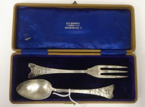 An Arts & Crafts spot-hammered silver presentation dessert spoon and fork  bearing initials on the