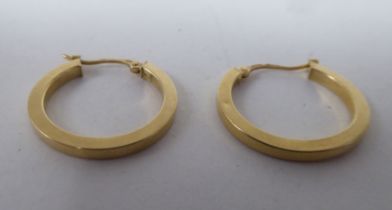 A pair of 18ct gold half-hoop earrings